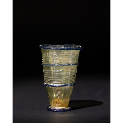 103 - A Roman Yellow & Blue Glass Beaker, Circa 1st Century AD.

H: Approximately 6cm