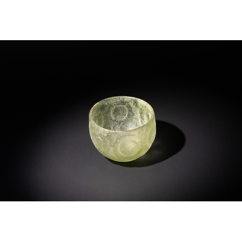 104 - An Early Sasanian Green Glass Facet-Cut Bowl, Circa 5th-6th Century A.D.

H: Approximately 7cm
D: Ap... 