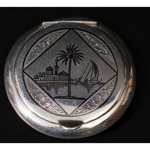 309 - An Islamic Iraqi Niello Silver Compact Mirror.

D: Approximately 6cm
63g

Provenance: Private W Lond... 