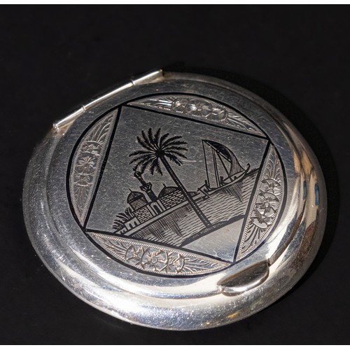 309 - An Islamic Iraqi Niello Silver Compact Mirror.

D: Approximately 6cm
63g

Provenance: Private W Lond... 