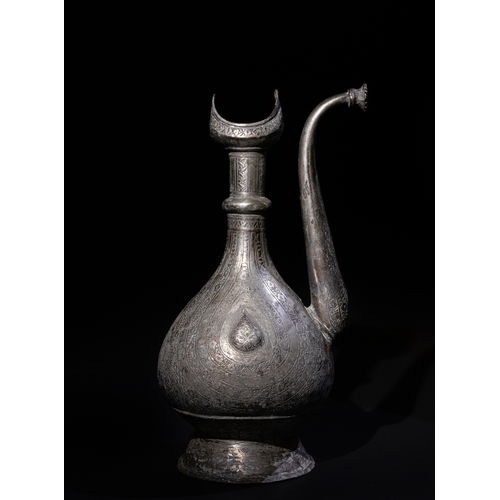 311 - An Islamic Persian Tinned Copper Ewer, 19th-20th Century, Engraved with Floral Motifs. 

H: Approxim... 