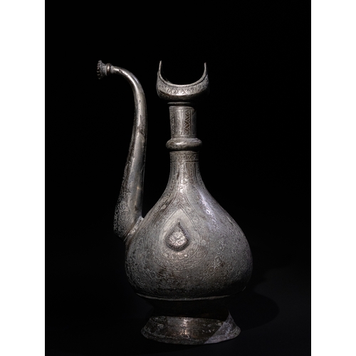 311 - An Islamic Persian Tinned Copper Ewer, 19th-20th Century, Engraved with Floral Motifs. 

H: Approxim... 