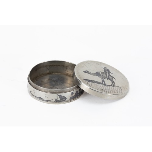 76 - An Islamic Iraqi Niello-Silver Pill Box with Desert and Maritime Motifs.

The lid features an engrav... 