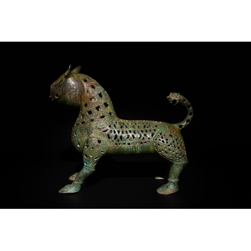 78 - An Islamic Bronze Lion Decorated with Intricate Openwork.

The lion's body is adorned with intricate... 