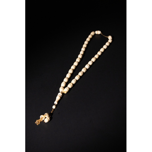 80 - An Islamic Bone Prayer Bead Necklace with Gold Detailing and Tassels.

This Islamic prayer bead neck... 