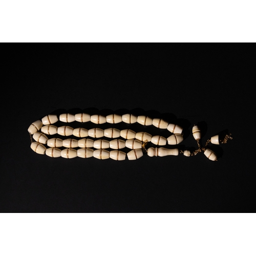 80 - An Islamic Bone Prayer Bead Necklace with Gold Detailing and Tassels.

This Islamic prayer bead neck... 