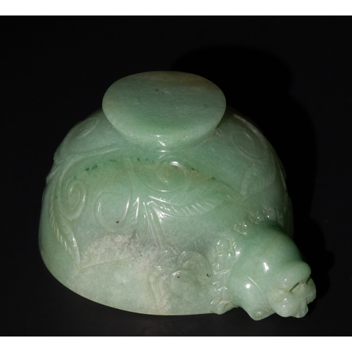 158 - A Mughal-Style Green Jade Bowl with Lion-Head Handle.

The bowl is adorned with floral motifs delica... 