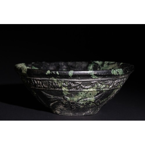 160 - A Mughal-Style Green Jade Bowl with Arabic Calligraphy and Floral Carvings.

The green jade provides... 