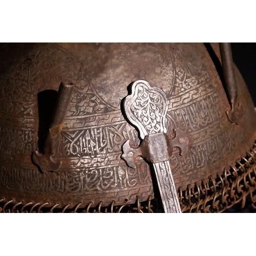 91 - An Islamic Indo-Persian Kulah-Khud Helmet with Calligraphic Engraving and Chainmail.

It features ex... 