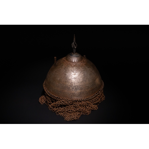 91 - An Islamic Indo-Persian Kulah-Khud Helmet with Calligraphic Engraving and Chainmail.

It features ex... 