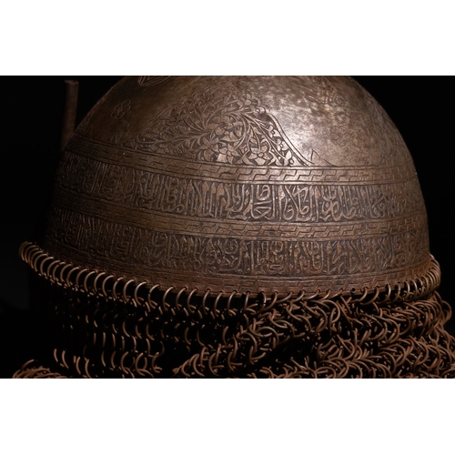 91 - An Islamic Indo-Persian Kulah-Khud Helmet with Calligraphic Engraving and Chainmail.

It features ex... 