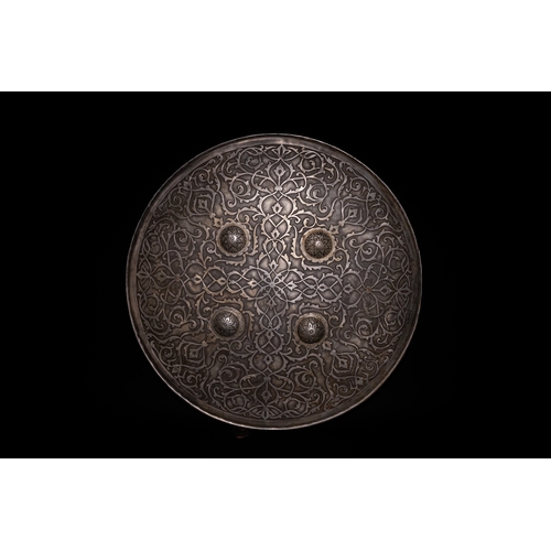 92 - An Islamic Indo-Persian Silver-Inlaid Steel Shield.

This Indo-Persian steel shield is adorned with ... 