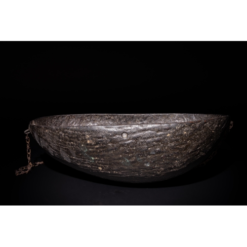 106 - An Islamic Qajar Coco de Mer Kashkul Beggar's Bowl, 19th Century, with Chain.

The bowl's surface is... 