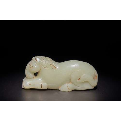 253 - A Chinese Carved Pale Green Jade Reclining Horse.

This Chinese carving features a horse in a reclin... 