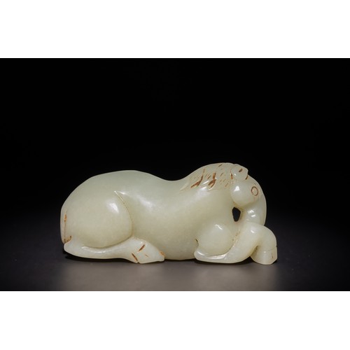 253 - A Chinese Carved Pale Green Jade Reclining Horse.

This Chinese carving features a horse in a reclin... 