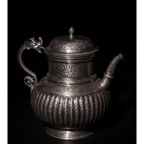 107 - An Islamic Timurid Copper Lidded Water Jug with Intricate Engraving.

The teapot is adorned with scr... 