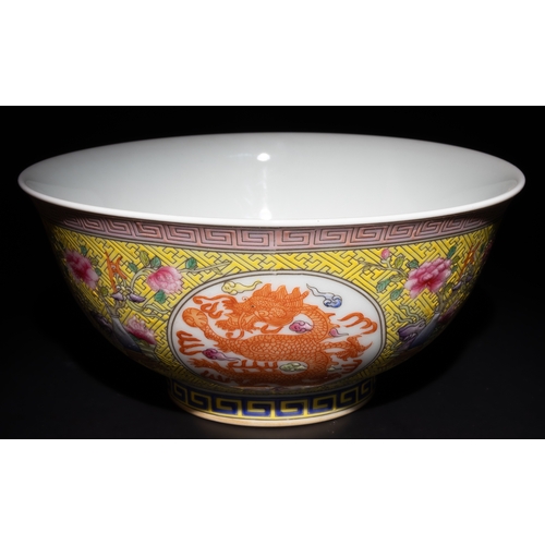 264 - A Chinese Famille Rose Yellow Ground Dragon Bowl with 4 Character Marks to the Base.

This Chinese p... 