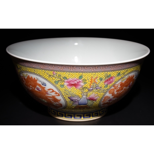 264 - A Chinese Famille Rose Yellow Ground Dragon Bowl with 4 Character Marks to the Base.

This Chinese p... 