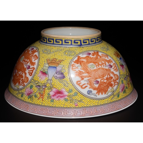 264 - A Chinese Famille Rose Yellow Ground Dragon Bowl with 4 Character Marks to the Base.

This Chinese p... 