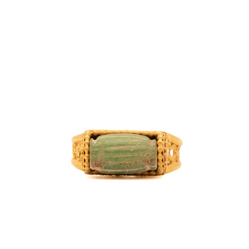 9 - A Byzantine Gold Ring with a Green Faience Stone Cabochon.

This Byzantine ring features an exquisit... 