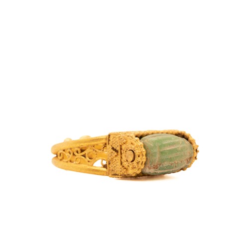 9 - A Byzantine Gold Ring with a Green Faience Stone Cabochon.

This Byzantine ring features an exquisit... 