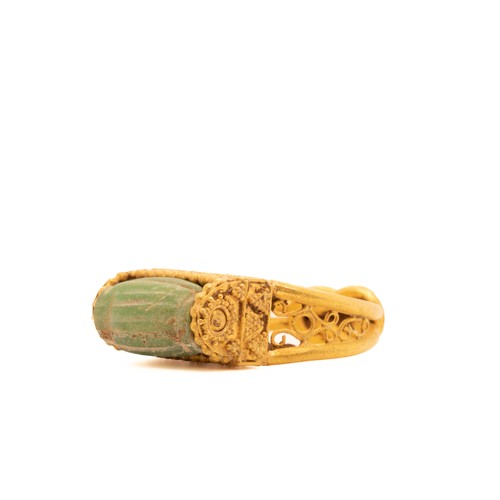 9 - A Byzantine Gold Ring with a Green Faience Stone Cabochon.

This Byzantine ring features an exquisit... 