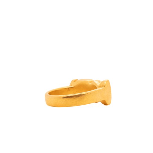 15 - An Egyptian Solid Gold Ring with Hieroglyphic Motif.

The ring features a solid band with engraved h... 