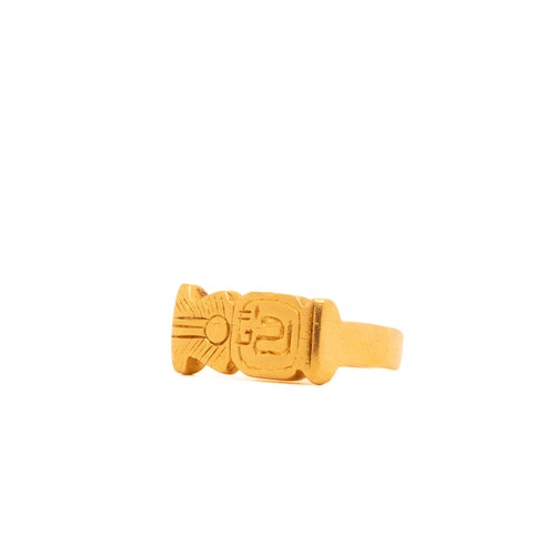 15 - An Egyptian Solid Gold Ring with Hieroglyphic Motif.

The ring features a solid band with engraved h... 