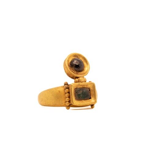 16 - A Byzantine Hollow Ring with Garnet and Emerald Cabochon.

This solid gold Byzantine ring features a... 