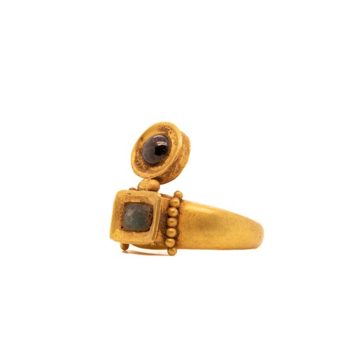 16 - A Byzantine Hollow Ring with Garnet and Emerald Cabochon.

This solid gold Byzantine ring features a... 