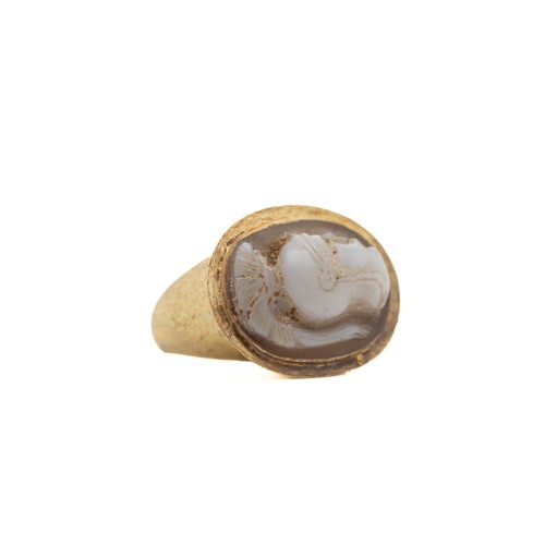 39 - A Roman Gold Hollow Ring with Cameo.

This Roman gold ring features a distinctive hollow band and is... 