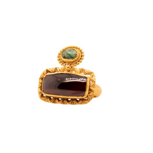 41 - A Byzantine Gold Ring with Garnet and Emerald.

A Byzantine gold ring featuring an oval garnet gemst... 