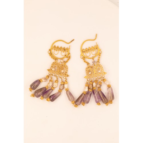 43 - A Pair of Byzantine Gold Earrings with Amethyst.

These striking Byzantine gold earrings showcase fi... 