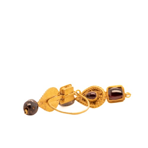 45 - A Pair of Byzantine Gold Earrings with Garnet.

This pair of Byzantine gold earrings showcases finel... 