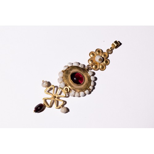 47 - A Byzantine Gold Pendant with Garnet and Pearls.

This Byzantine pendant features a central garnet s... 