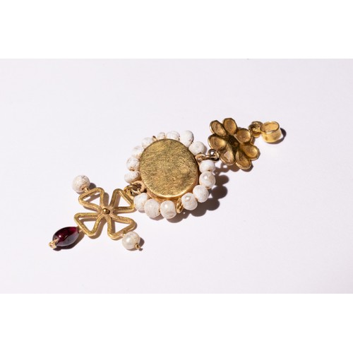 47 - A Byzantine Gold Pendant with Garnet and Pearls.

This Byzantine pendant features a central garnet s... 