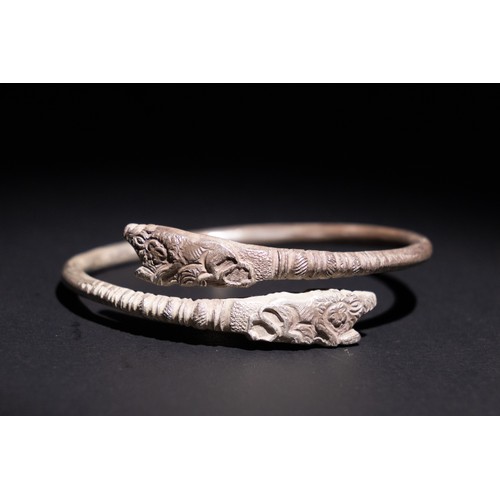 51 - A Roman Silver Bracelet with Animal Head Terminals.

A silver bracelet featuring terminals shaped li... 