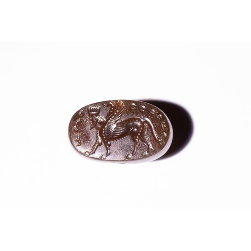 61 - A Sassanian Agate Stamp Seal with Inscription and Winged Griffin Design, 224-642 AD.

A brown agate ... 