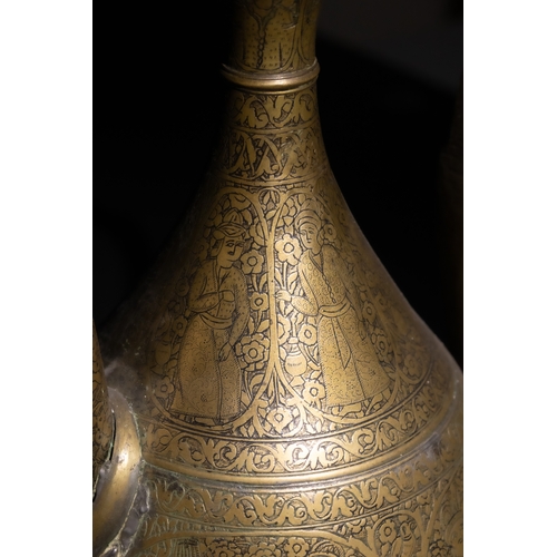 110 - An Islamic Qajar Brass Ewer with Intricate Floral Engravings, 19th Century.

This Qajar brass ewer f... 