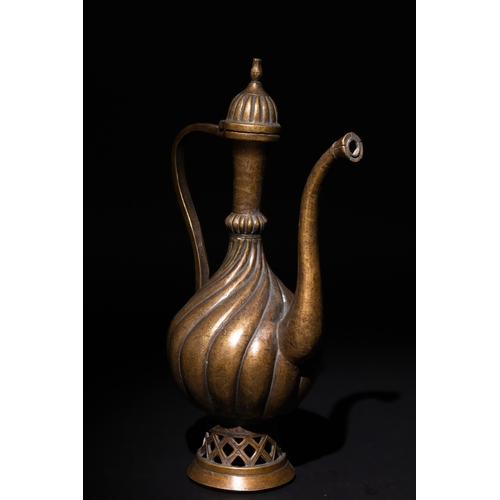 112 - An Islamic Ottoman Bronze Ewer with Fluted Design.

An Ottoman bronze ewer featuring an elegant flut... 