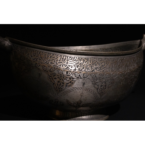 115 - A Persian Tinned-Copper Kashkul with Dragon Handles, 17th Century.

A tinned-copper vessel featuring... 