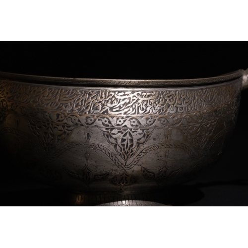 115 - A Persian Tinned-Copper Kashkul with Dragon Handles, 17th Century.

A tinned-copper vessel featuring... 