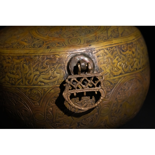 116 - A Qajar Brass Kashkul Beggar's Bowl with Islamic Calligraphy, 19th Century.

A brass Kashkul featuri... 