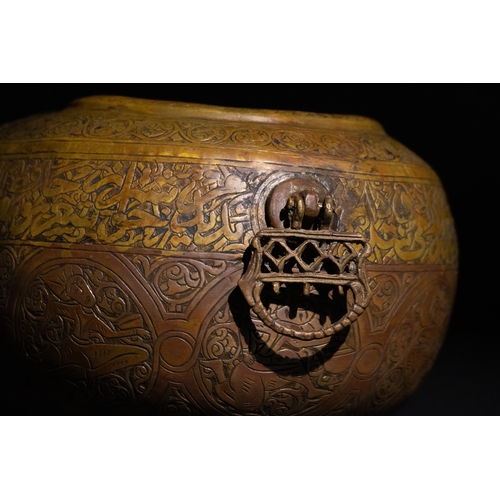 116 - A Qajar Brass Kashkul Beggar's Bowl with Islamic Calligraphy, 19th Century.

A brass Kashkul featuri... 