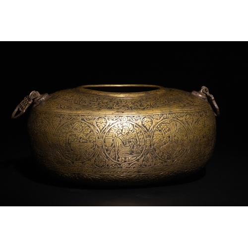 117 - A Qajar Brass Kashkul Beggar's Bowl with Islamic Calligraphy and Figural Scenes, 19th Century.

The ... 