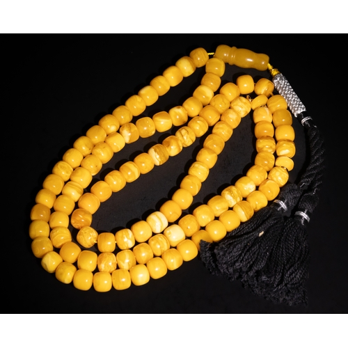 126 - An Islamic Amber Prayer Beads Tasbih with Black Tassel.

Each bead is smoothly rounded, contributing... 