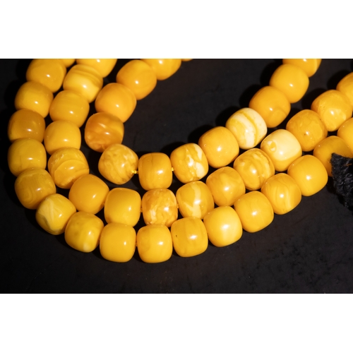 126 - An Islamic Amber Prayer Beads Tasbih with Black Tassel.

Each bead is smoothly rounded, contributing... 