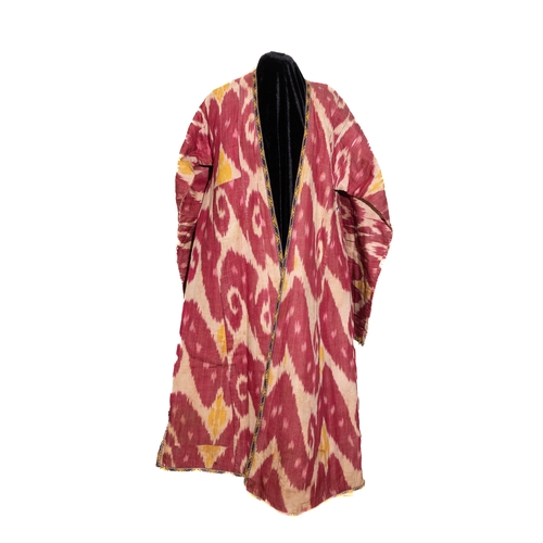 136 - An Uzbek Silk Ikat Chapan Robe, Late 19th Century.

This silk ikat robe showcases bold patterns in h... 