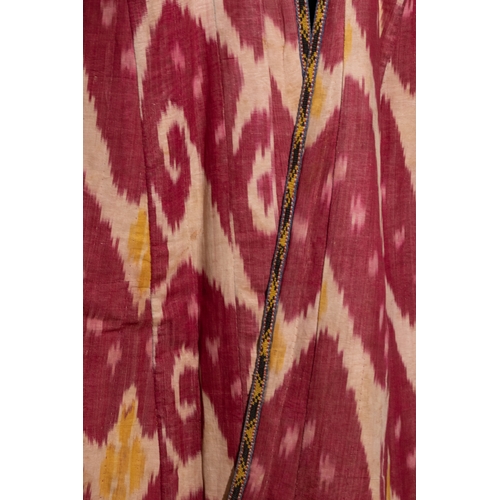 136 - An Uzbek Silk Ikat Chapan Robe, Late 19th Century.

This silk ikat robe showcases bold patterns in h... 