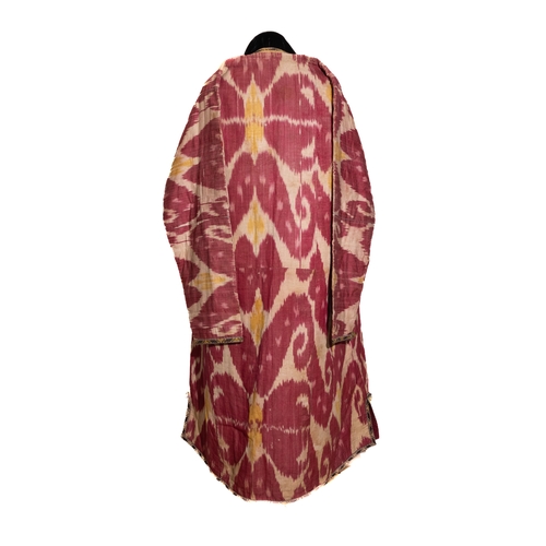 136 - An Uzbek Silk Ikat Chapan Robe, Late 19th Century.

This silk ikat robe showcases bold patterns in h... 